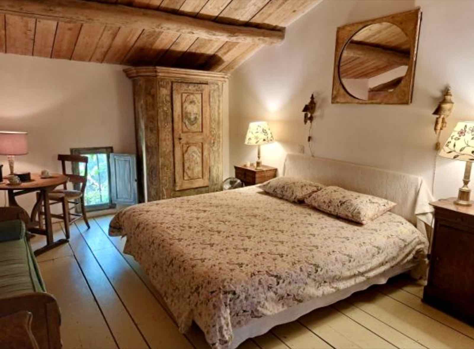 Chambre du mas avec poutres apparentes et mobilier ancien